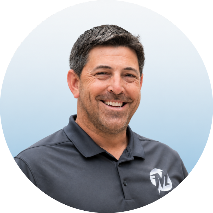 Headshot of Nick Demos smiling in a dark grey polo shirt with a logo.