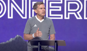 Jim Brown speaking at Momentum Youth Conference 2026.